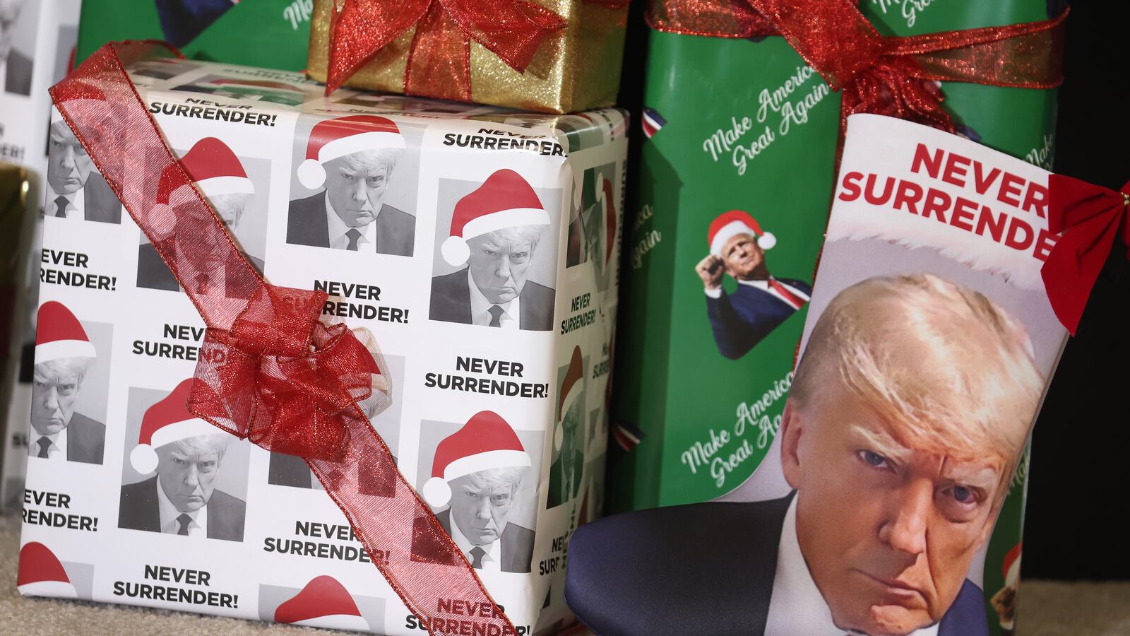 WATERLOO, IOWA - DECEMBER 19: Gifts wrapped in Christmas wrapping paper featuring the likeness of Republican presidential candidate former U.S. President Donald Trump sit on the stage during a rally hosted by the former president on December 19, 2023 in Waterloo, Iowa. Iowa Republicans will be the first to select their party's nomination for the 2024 presidential race, when they go to caucus on January 15, 2024. (Photo by Scott Olson/Getty Images)
