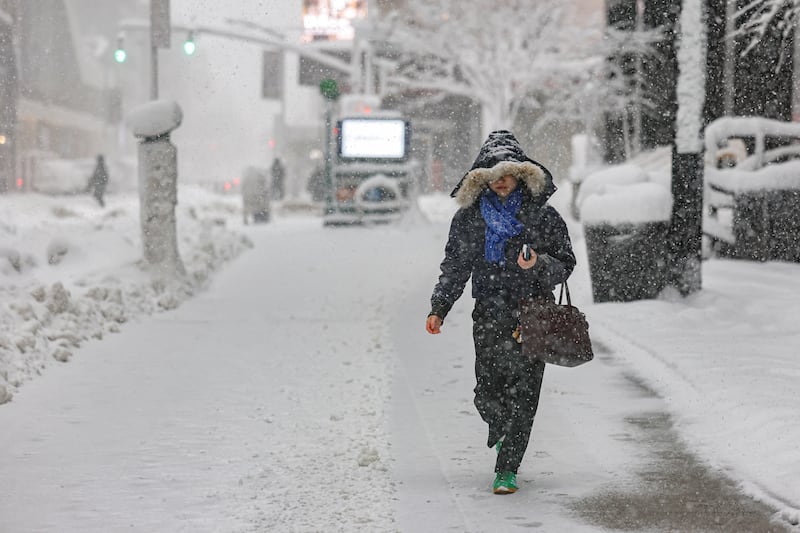 A pedestrian walks on a street as snow falls during a winter storm in New York City, U.S., February 23, 2026.