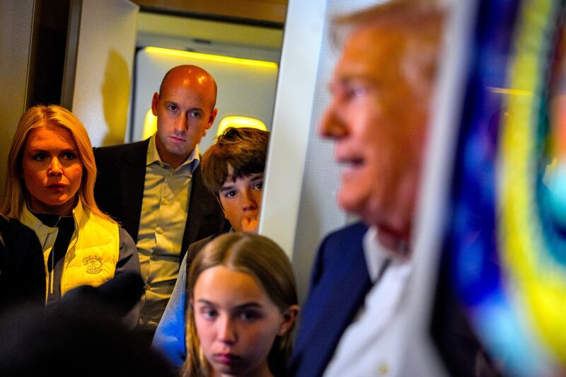 President Donald Trump (R), accompanied by White House press secretary Karoline Leavitt (L), White House Deputy Chief of Staff Stephen Miller