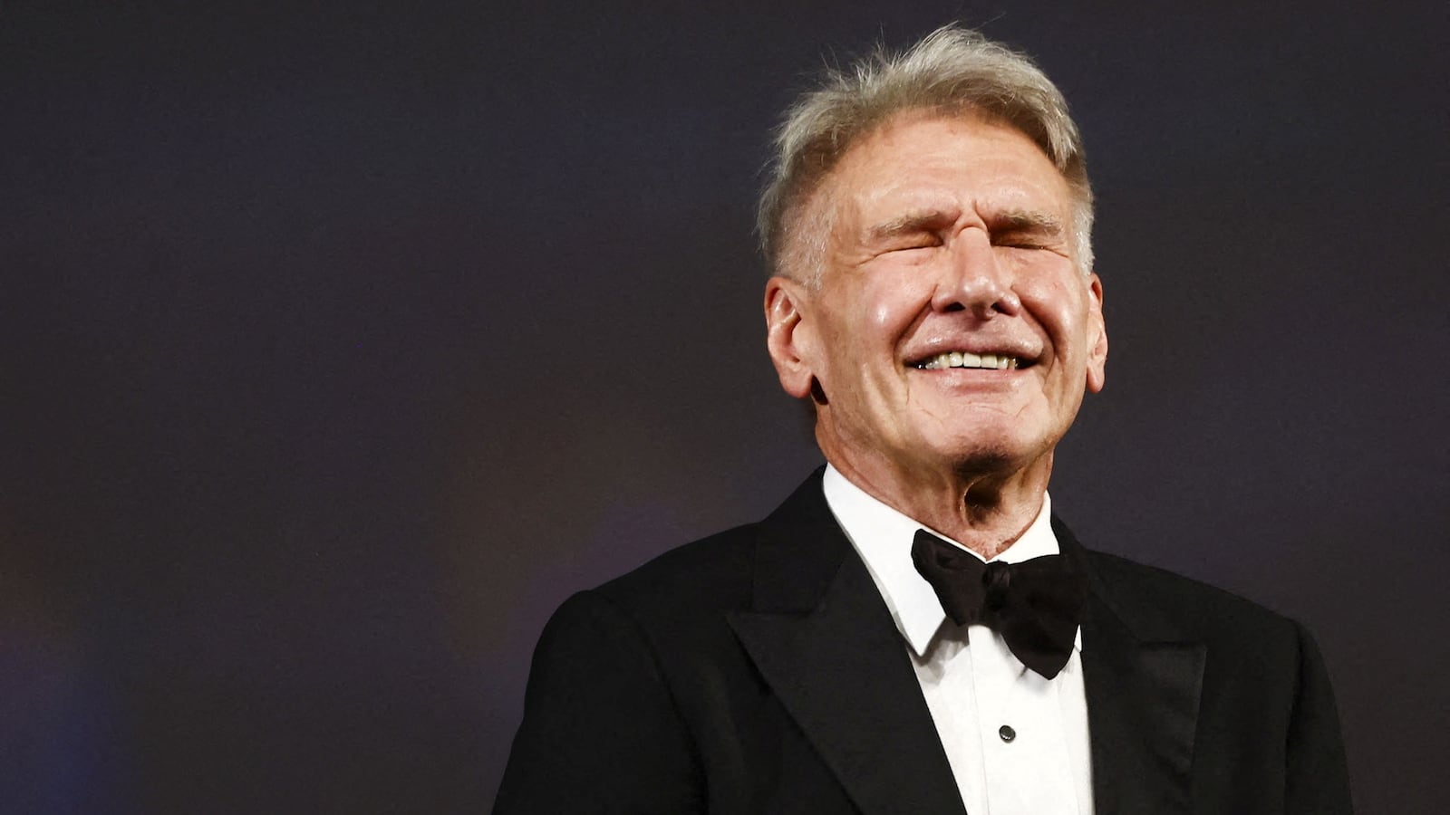 Actor Harrison Ford reacts while being presented with an Honorary Palme d'Or Award.