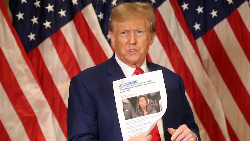 NEW YORK, NEW YORK - JANUARY 11: Former U.S. President Donald Trump holds up a news story about New York Attorney General Letitia James as he speaks to the media at one of his properties at 40 Wall Street following closing arguments at his civil fraud trial on January 11, 2024 in New York City. The former president, who is currently the front runner for the Republican nomination, attended the closing arguments for the trial which will now go to the judge for the penalty phase in which New York Attorney General Letitia James is seeking $370 million in damages and to prohibit Trump from doing business in the state. (Photo by Spencer Platt/Getty Images)