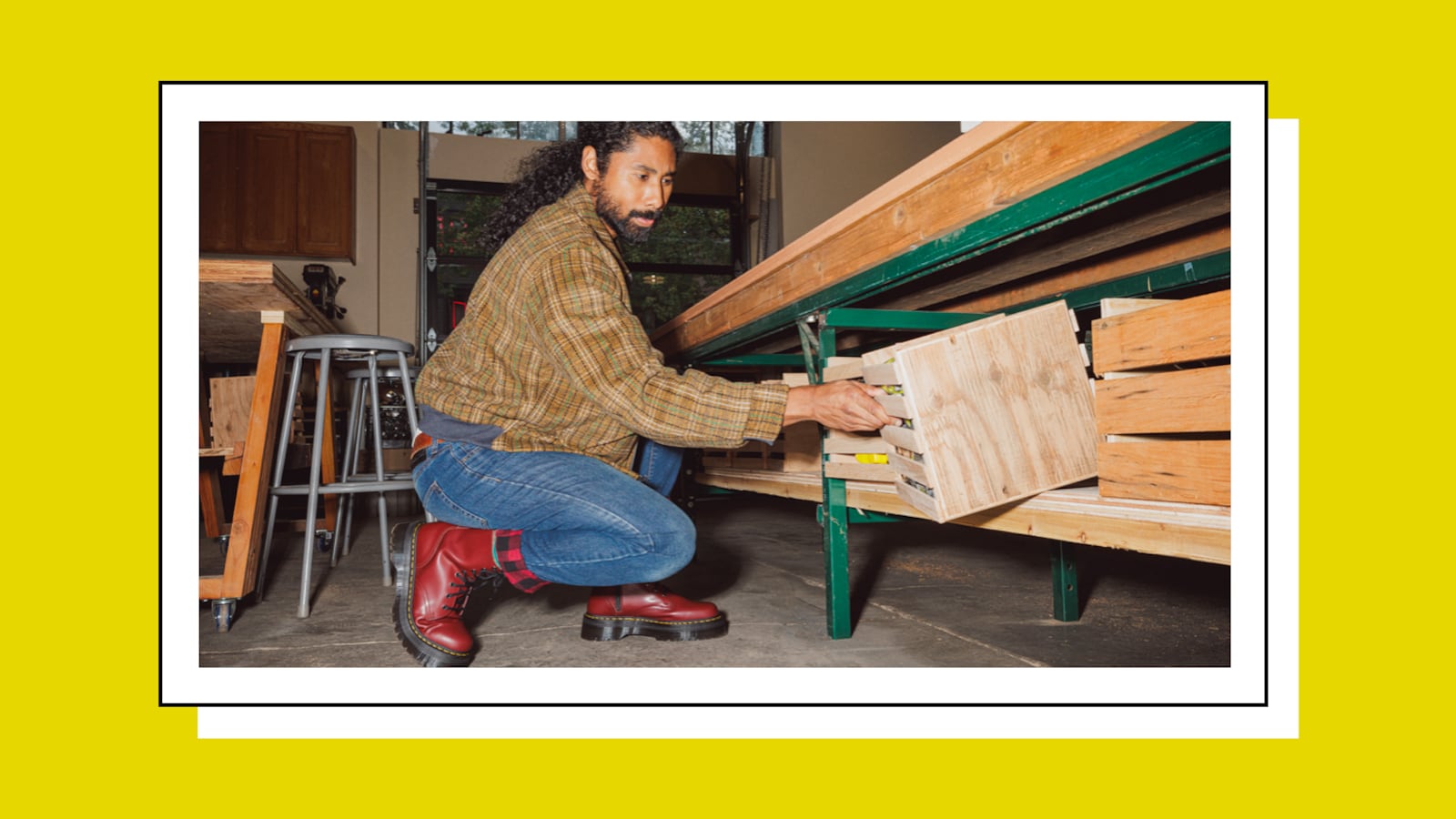 Man wearing Dr. Martens boots working.