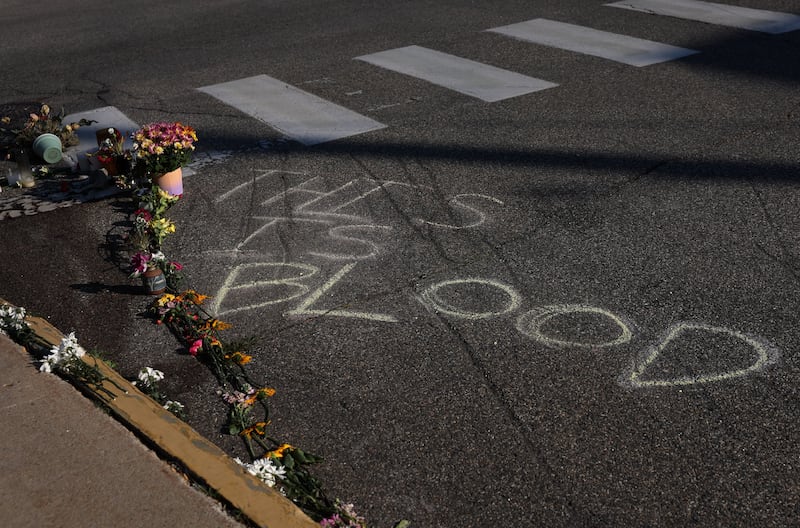 Flowers and writing on the ground at a makeshift street-side memorial for Johan Sebastian Duran, a driver who was fatally shot on July 13 by U.S. Immigration and Customs Enforcement (ICE) agents, in Biddeford, Maine, U.S., July 15, 2026.