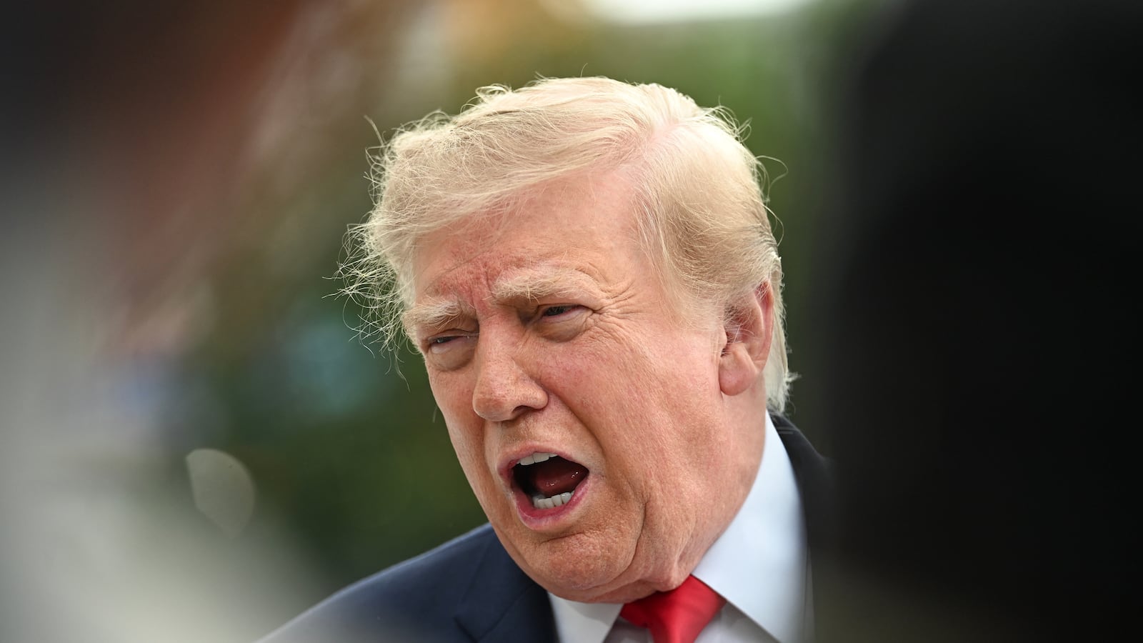 US President Donald Trump speaks to members of the press before boarding Marine One as he departs from the South Lawn of the White House in Washington, DC, on September 26, 2026. US President Donald Trump is heading to Knoxville, Tennessee to attend the Tennessee/Texas college football game.