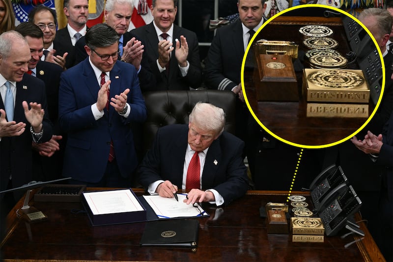 Donald Trump signs the bill package to re-open the federal government in the Oval Office of the White House in Washington, DC, on November 12, 2025, with a circle highlighting an enlarged part of the image showing a gold bar and Rolex clock on Trump's desk