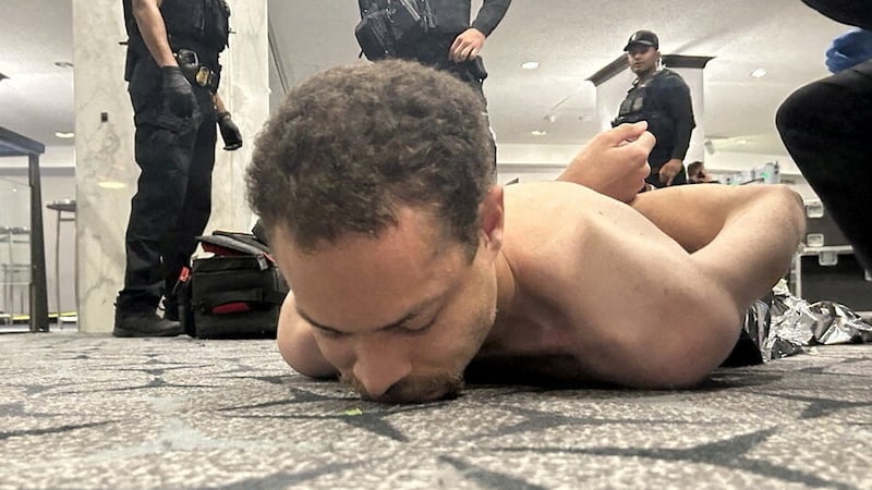 Officers detain Cole Tomas Allen at the White House Correspondents' Association dinner this past weekend. DONALD J TRUMP via Truth Social/Handout via REUTERS.