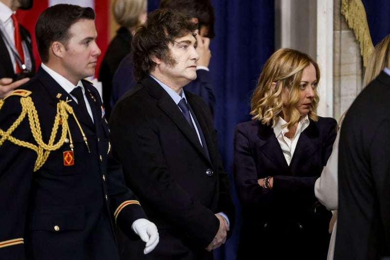 Italy’s Prime Minster Giorgia Meloni (R) and Argentina’s President Javier Milei (C) attend Donald Trump’s inauguration as the next President of the United States in the rotunda of the United States Capitol in Washington, DC, USA, 20 January 2025. Trump, who defeated Kamala Harris, is being sworn in today as the 47th president of the United States, though the planned outdoor ceremonies and events have been cancelled due to a forecast of extreme cold temperatures.    SHAWN THEW/POOL/Pool via REUTERS