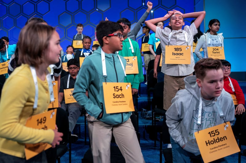 Spellers stretch during a commercial break on the day of the quarterfinals of the annual Scripps National Spelling Bee in National Harbor, Maryland, U.S., May 28, 2025.
