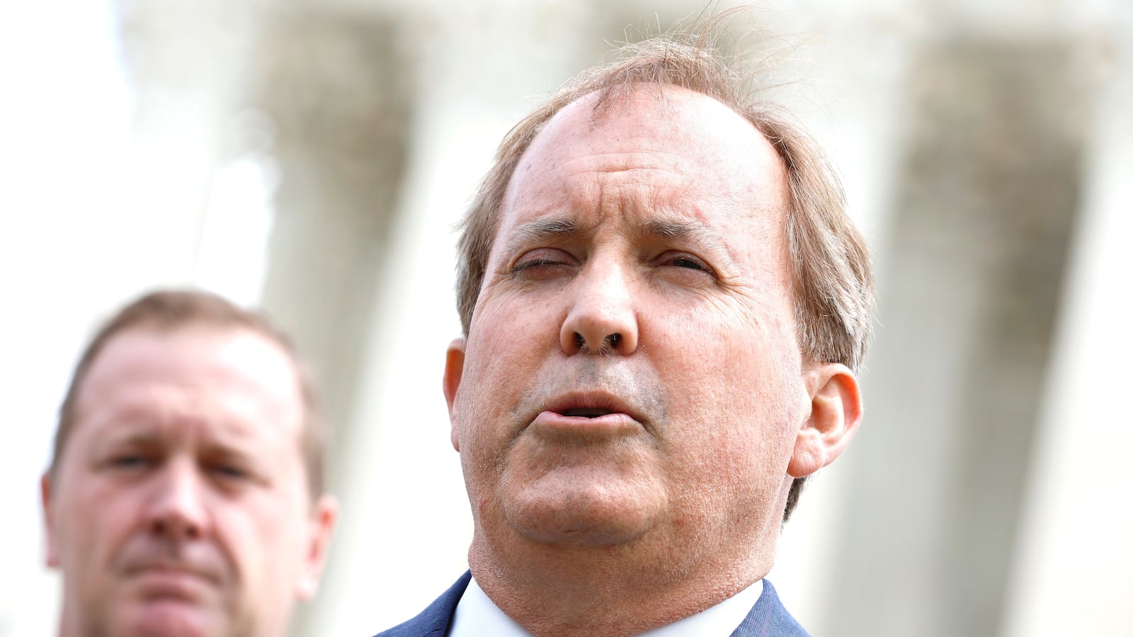 Texas Attorney General Ken Paxton (R) and Missouri Attorney General Eric Schmitt talk to reporters after the U.S. Supreme Court heard arguments in their case about Title 42 on April 26, 2022 in Washington, DC.
