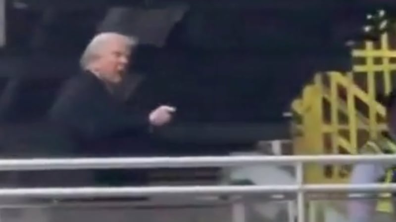 Donald Trump points and flips the bird at someone who called him a "pedophile protector" in Michigan.