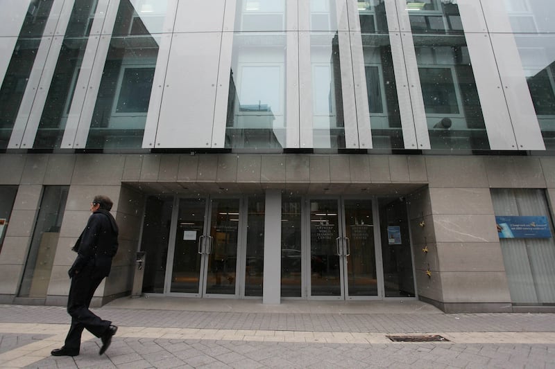 A pedestrian walks past the Antwerp World Diamond Center (AWDC) building which is one of the world's most important diamond-trading centres, on March 8,2010. Robbers held an Indian diamond merchant hostage for 18 hours at the merchant's home in the northern city of Antwerp before freeing him in return for millions of euros' (USD millions) of worth of gems. AFP PHOTO BELGA JULIEN WARNAND **BELGIUM-OUT** (Photo by JULIEN WARNAND / BELGA / AFP via Getty Images)