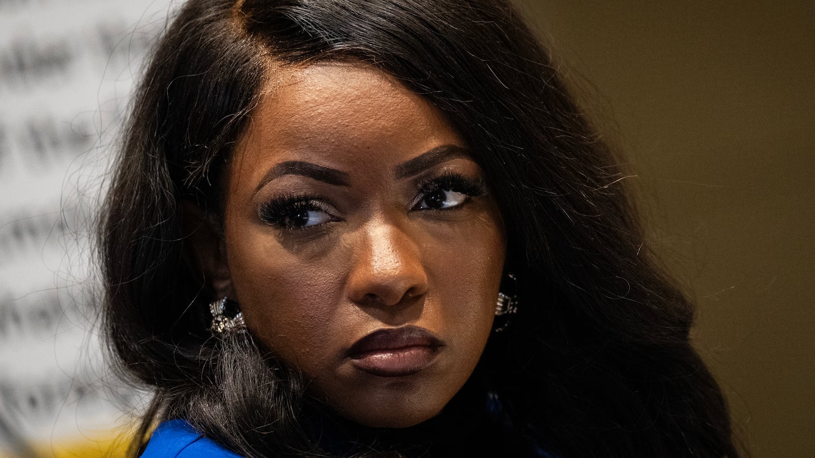 Rep. Jasmine Crockett (D-TX) listens during a media briefing concerning former President Donald Trump's business ties with foreign governments, on Capitol Hill January 4, 2024 in Washington, DC.