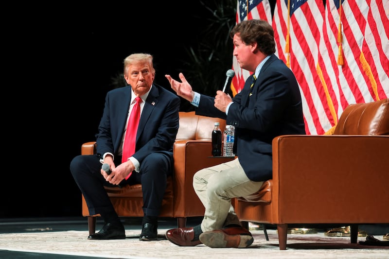 Republican presidential nominee and former U.S. President Donald Trump participates in a fireside chat with Tucker Carlson at 'Tucker Carlson Live on Tour' at Desert Diamond Arena, in Glendale, Arizona, U.S. October 31, 2024. REUTERS/Brendan McDermid