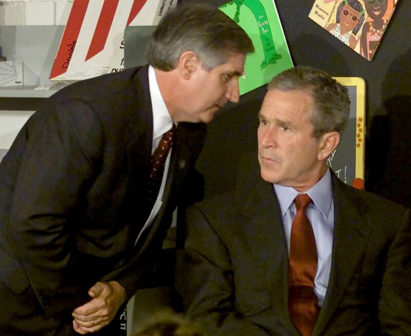 President George W. Bush listens as White House Chief of Staff Andrew Card informs him of a second plane hitting the World Trade Center while Bush was conducting a reading seminar at the Emma E. Booker Elementary School in Sarasota, Florida in this September 11, 2001.