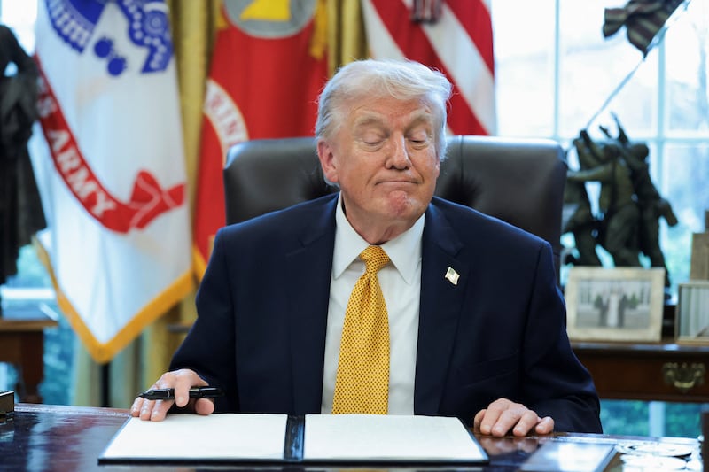 U.S. President Donald Trump reacts during an event to sign an executive order creating an anti‑fraud task force headed by U.S. Vice President JD Vance in the Oval Office at the White House in Washington, D.C., U.S., March 16, 2026.