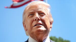 WASHINGTON, DC - MAY 12: U.S. President Donald Trump speaks in front of the American flag to the press as he departs the White House on May 12, 2026 in Washington, DC. Trump is traveling to China where he is scheduled to meet with Chinese President Xi Jinping for expected talks on the Iran conflict, trade imbalances, regional security, and economic cooperation between the two countries. (Photo by Kevin Dietsch/Getty Images)