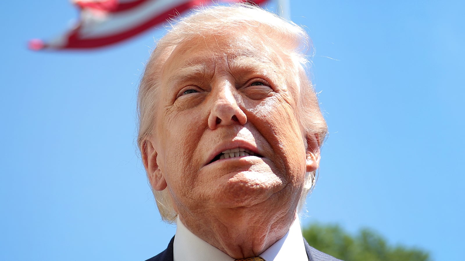 WASHINGTON, DC - MAY 12: U.S. President Donald Trump speaks in front of the American flag to the press as he departs the White House on May 12, 2026 in Washington, DC. Trump is traveling to China where he is scheduled to meet with Chinese President Xi Jinping for expected talks on the Iran conflict, trade imbalances, regional security, and economic cooperation between the two countries. (Photo by Kevin Dietsch/Getty Images)