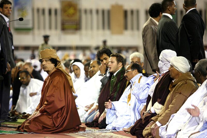 galleries/2011/10/20/muammar-gaddafi-reportedly-captured-and-killed-photos/gaddafi-obituary-prayer-2009_er78ey