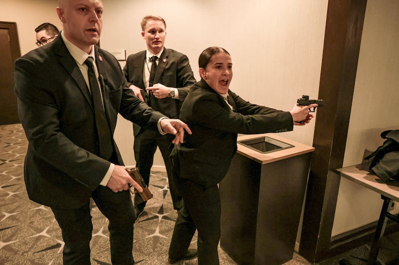 Security officials react as a shooter opens fire during the annual White House Correspondents' Association dinner in Washington, D.C., U.S., April 25, 2026.