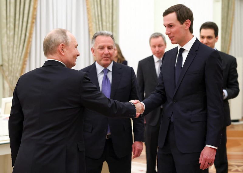 Jared Kushner shakes hands with Russian President Vladimir Putin while U.S. Special Envoy Steve Witkoff  looks on at a meeting at the Kremlin in Moscow on January 22, 2026.