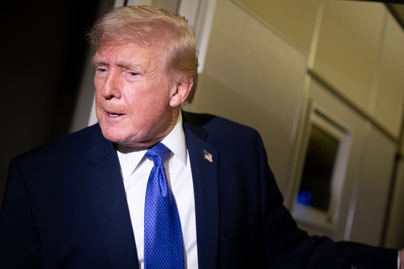 President Donald Trump speaks to members of the media aboard Air Force One while flying from Palm Beach International Airport on February 16, 2026 en route to Washington, DC.