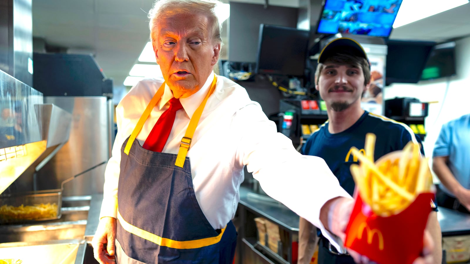 Donald Trump as he works behind the counter during a visit to McDonalds in Feasterville-Trevose, PA, Sunday, Oct. 20, 2024.