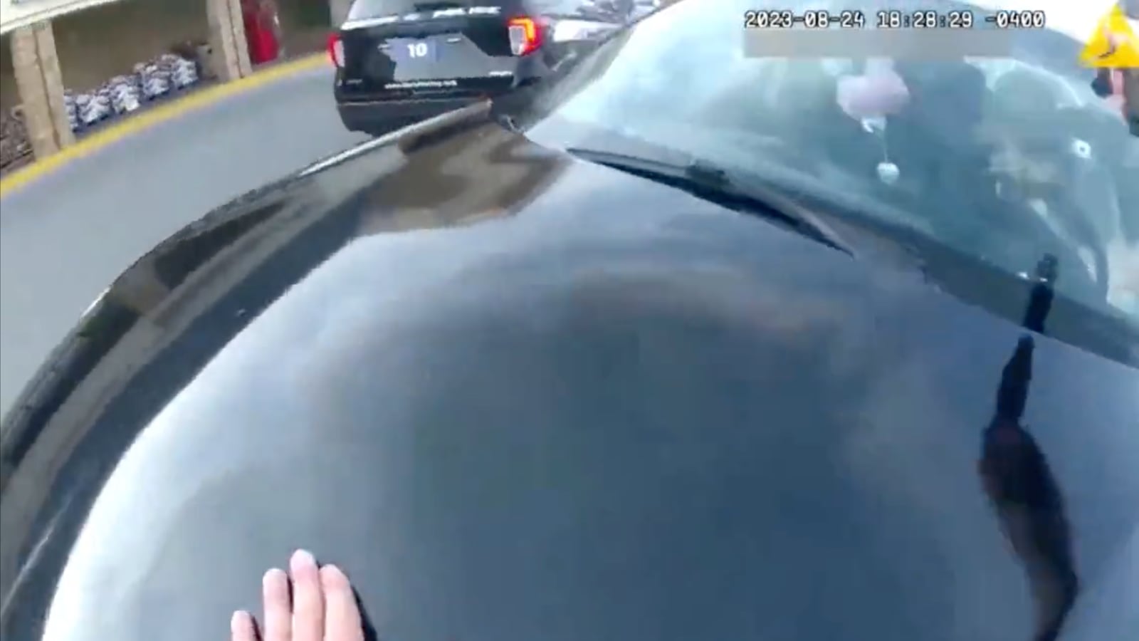A screengrab of body-camera footage that shows the second an officer fired a shot through a windshield that killed a pregnant woman and her unborn child.