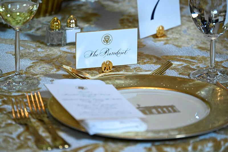 The sit at the table for US President Donald Trump is pictured during a dinner with donors in the East Room of the White House in Washington, DC on October 15, 2025.