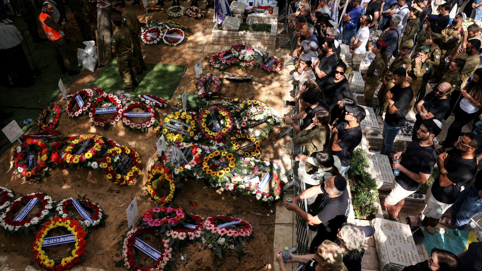 Israeli mourners attend the funerals of people who were slain in the assault on Israel by Hamas gunmen from the Gaza Strip.