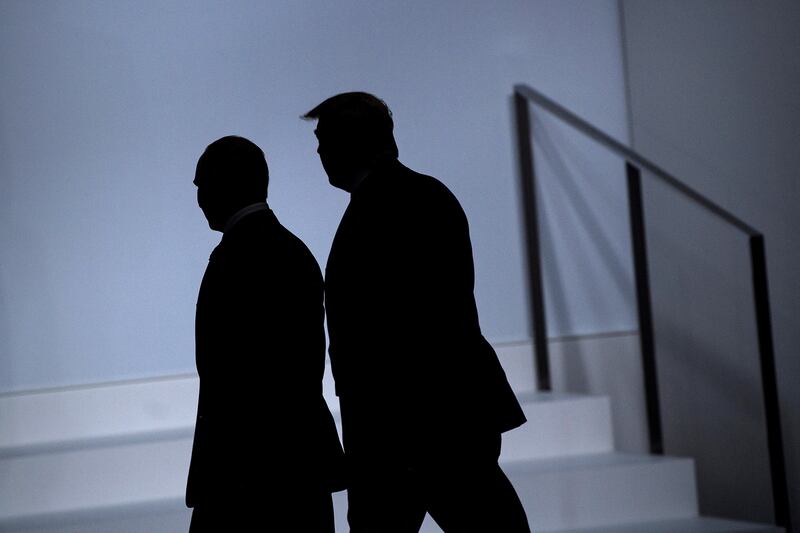 Russian President Vladimir Putin (L) and President Donald Trump arrive for a group photo at the G20 Summit in Osaka on June 28, 2019.