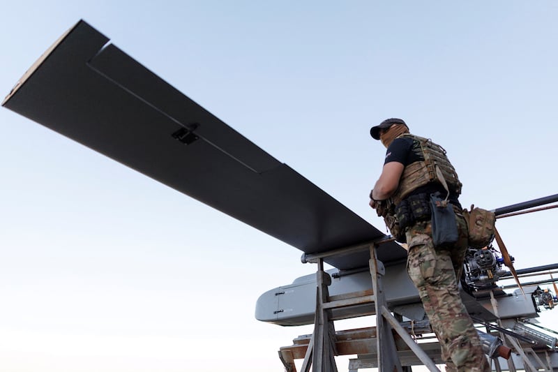 A service member of the 414th Separate Unmanned Strike Aviation System Brigade 'Magyar's Birds' of the Ukrainian Armed Forces stands next to FP-1 deep-strike drones before their launch for a combat mission, amid Russia's attack on Ukraine, in an undisclosed location in Ukraine, in 2026. REUTERS/Valentyn Ogirenko