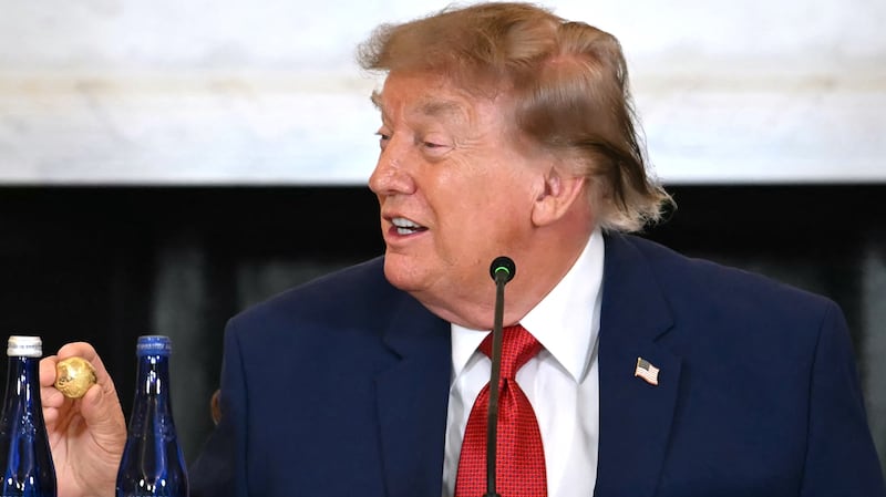 Donald Trump holds a solid gold replica of a deep sea nodule.