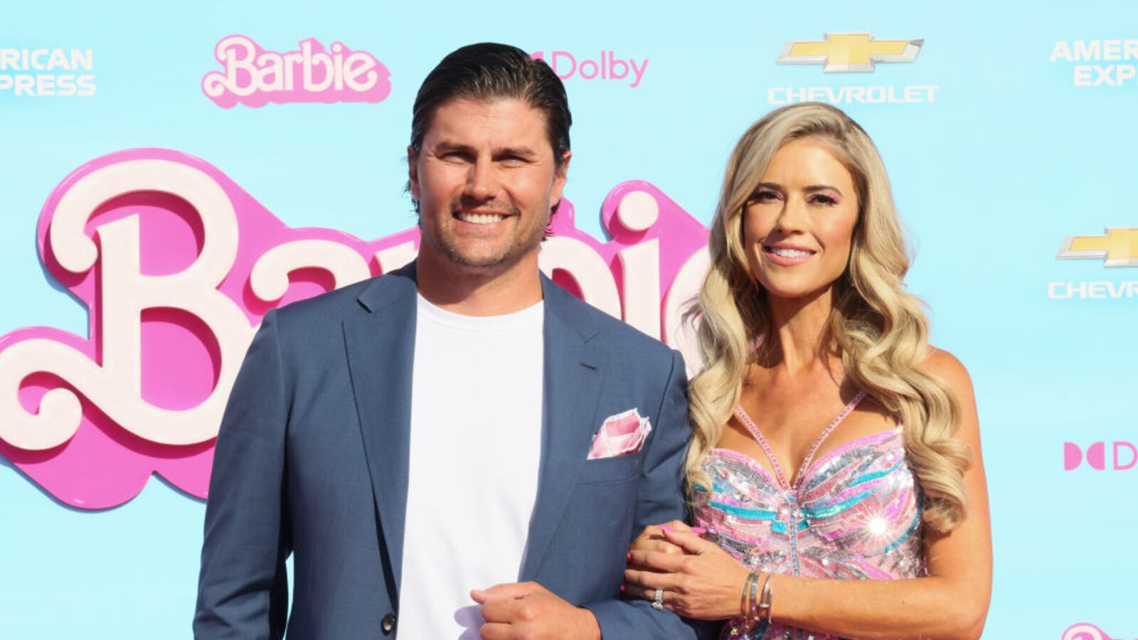 Josh and Christina Hall smile together at an event for the Barbie movie.
