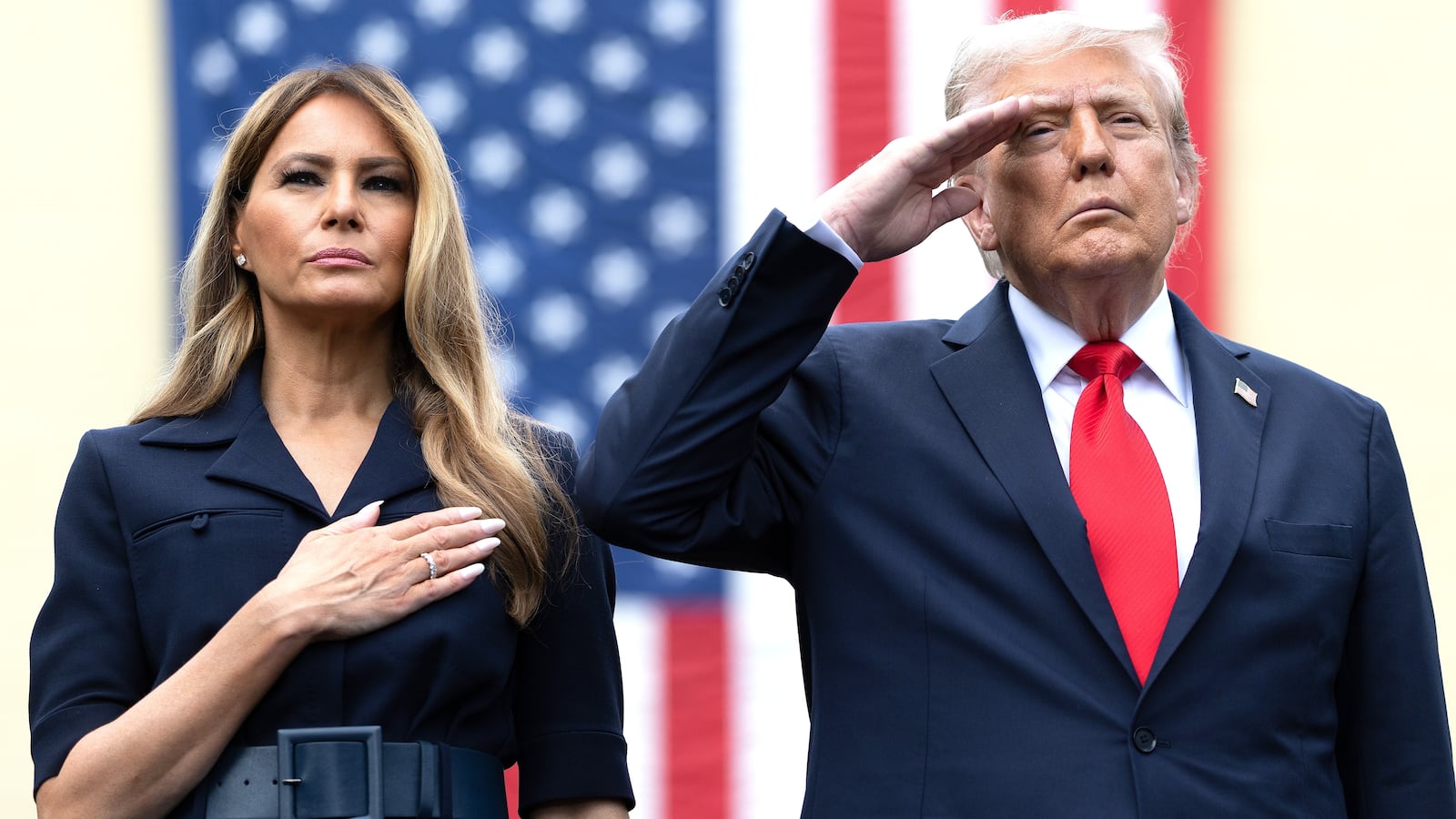 U.S. President Donald Trump salutes during the playing of "Taps" with first lady Melania Trump during a September 11th observance event in the courtyard of the Pentagon September 11, 2025 in Arlington, Virginia.