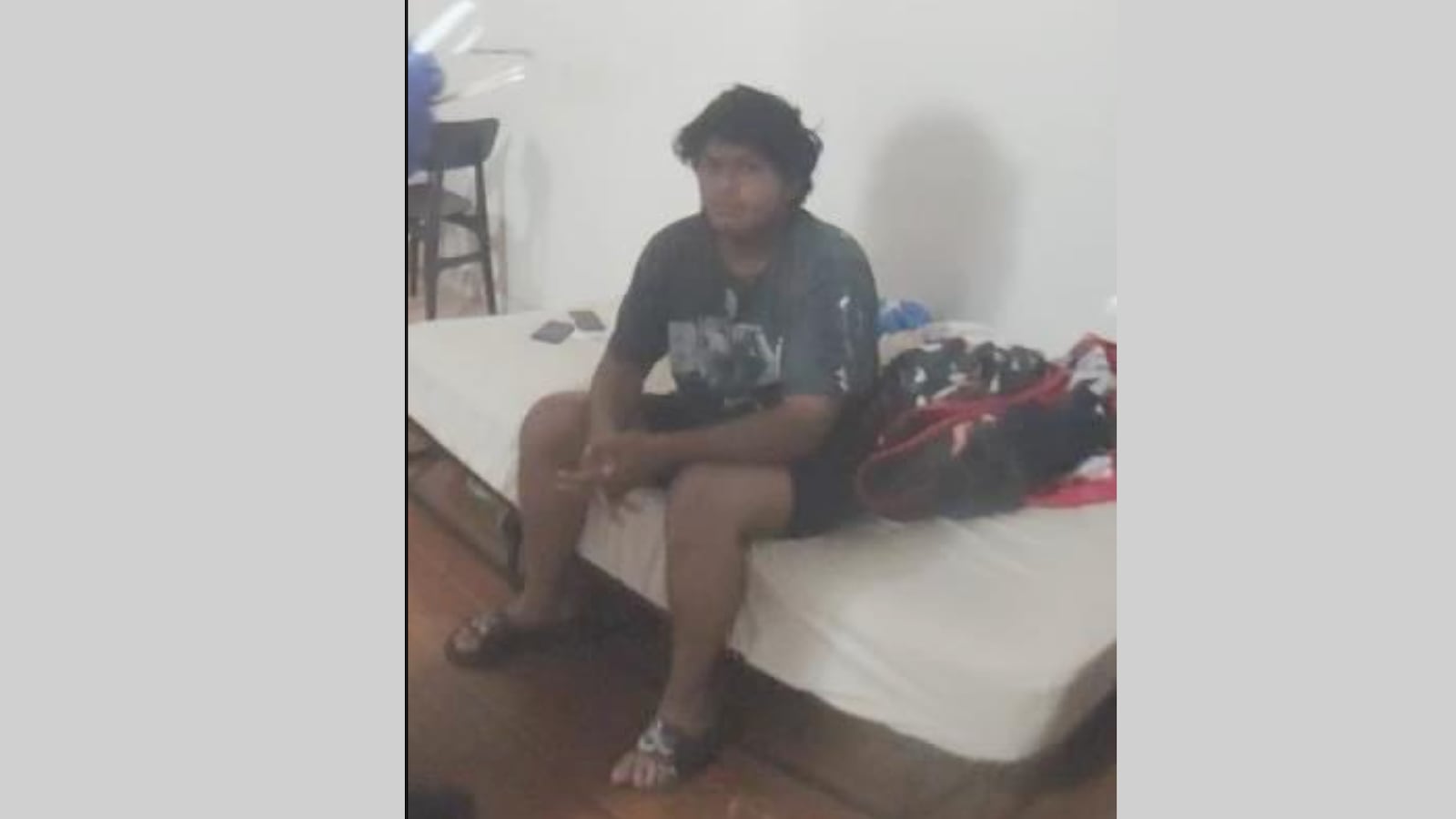 Murder suspect Juan Carlos Garcia-Rodriguez is seen sitting on a bed in police bodycam footage.