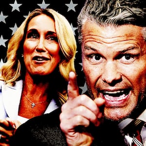 Jennifer and Pete Hegseth in front of a black and white flag.