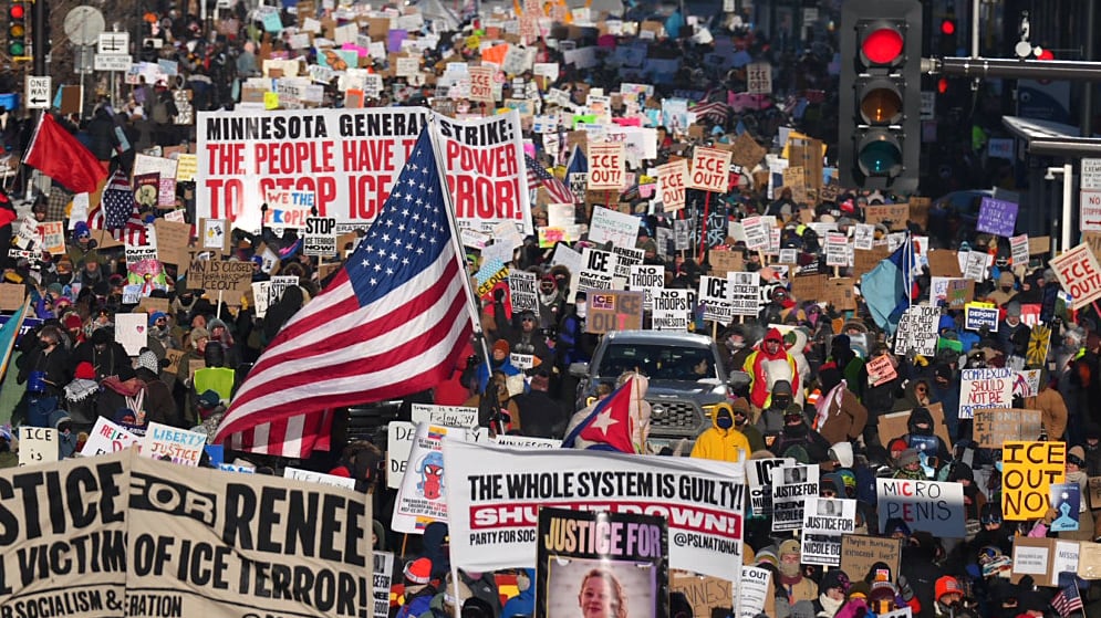 MINNEAPOLIS, MN. - JANUARY 2026: In sub-zero temperatures, marchers in downtown Minneapolis, Minn., on Friday, January 23, 2026, waved signs decrying ongoing immigration enforcement operations in the Twin Cities metro area, Operation Metro Surge. On Wednesday, January 7, 2026, Renee Nicole Good was shot and killed by an Immigration and Customs Enforcement (ICE) agent, Jonathan Ross, during a confrontation between federal agents and protesters in south Minneapolis.