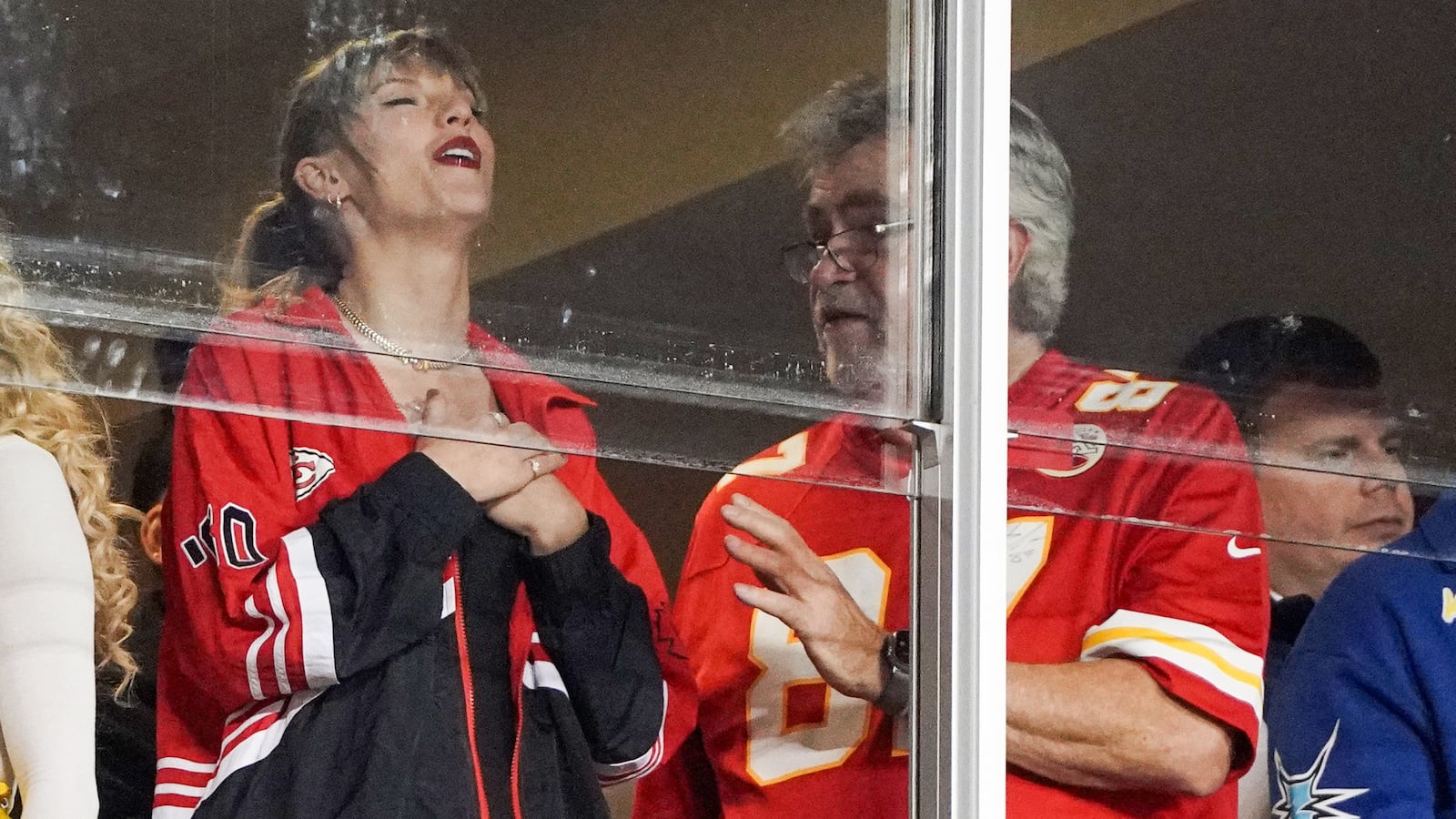 Recording artist Taylor Swift laughs while talking to Ed Kelce (Travis Kelce’s father)