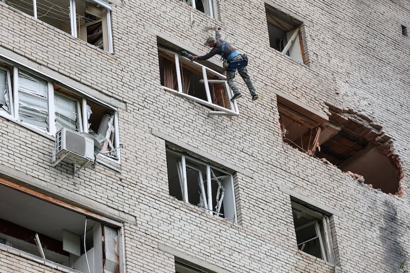 A worker checks a damaged apartment building following a Ukrainian drone attack, according to regional authorities, in the course of the Russia-Ukraine conflict, in the town of Solnechnogorsk, Moscow region, Russia, July 13, 2026.