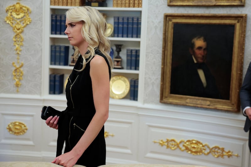 Natalie Harp, executive assistant to U.S. President Donald Trump, listens as Trump, not pictured, signs the Secure America Act in the Oval Office at the White House in Washington, D.C., U.S., June 10, 2026.