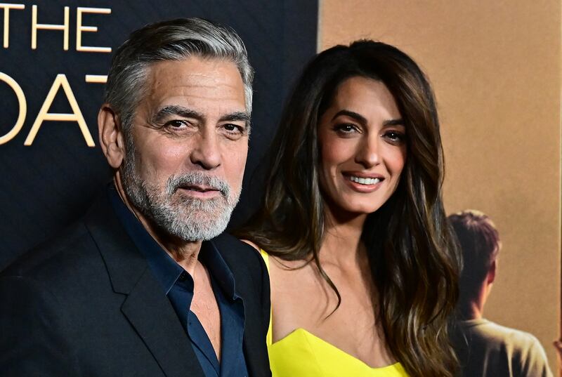 TOPSHOT - US actor George Clooney and his wife Lebanese-British barrister Amal Clooney attend the LA premiere of Amazon MGM Studios' "The Boys in the boat" at the Samuel Goldwyn theatre in Beverly Hills, California, December 11, 2023. (Photo by Frederic J. BROWN / AFP) / ALTERNATE CROP (Photo by FREDERIC J. BROWN/AFP via Getty Images)