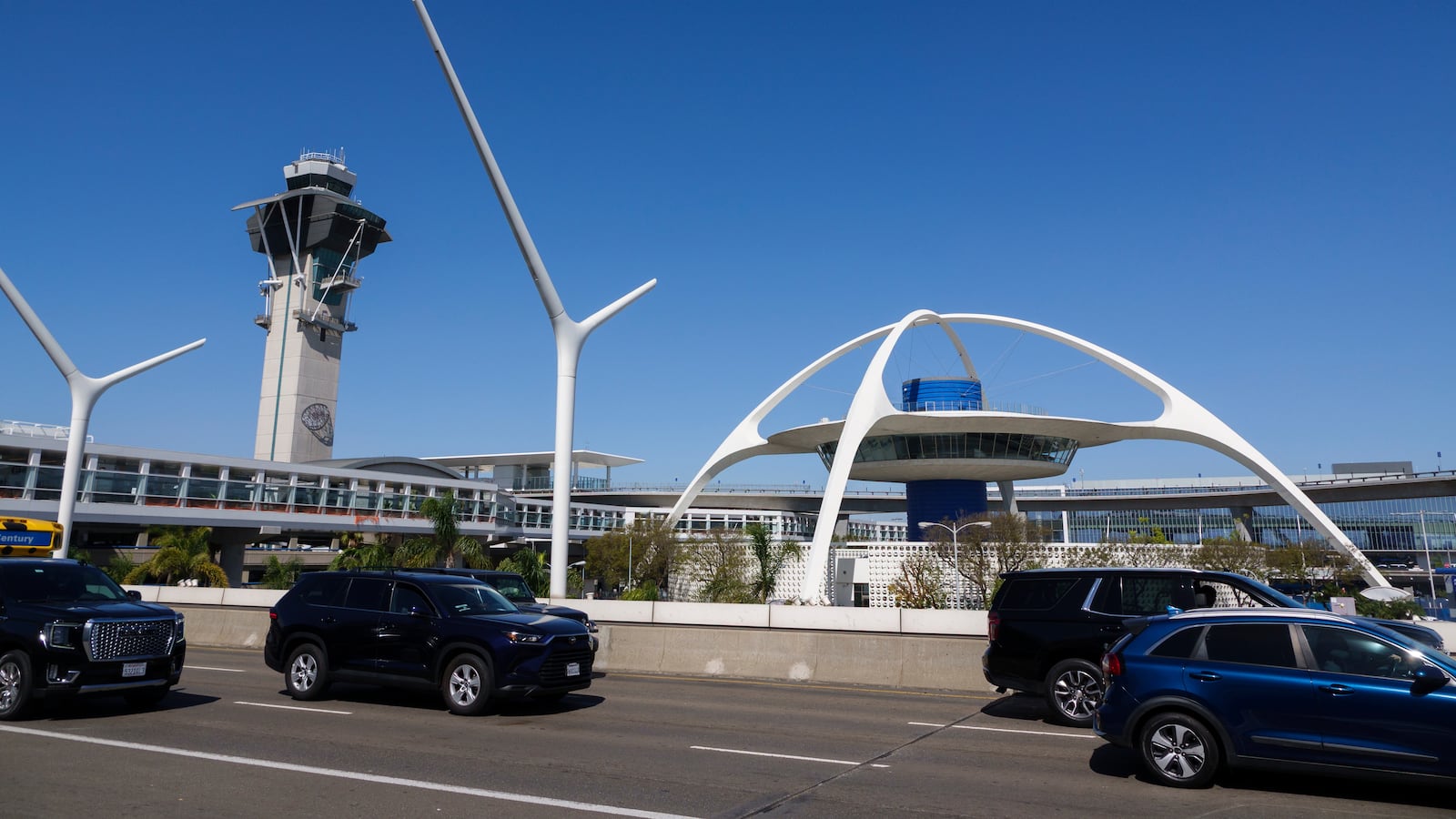 LOS ANGELES, CALIFORNIA - MARCH 7: People drive at Los Angeles International Airport with the air traffic control tower in the background on March 7, 2026 in Los Angeles, California. (Photo by Kevin Carter/Getty Images)
