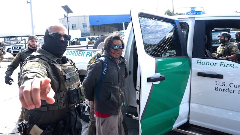 A person is detained by US Customs and Border Patrol (CBP) agents near a Lowe's hardware store in New Orleans, Louisiana