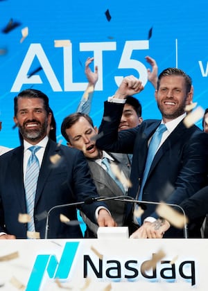 Zach Witkoff, Donald Trump Jr., and Eric Trump ring the stock market opening bell last summer. Each family stands to benefit from deals the Trump administration is making.
