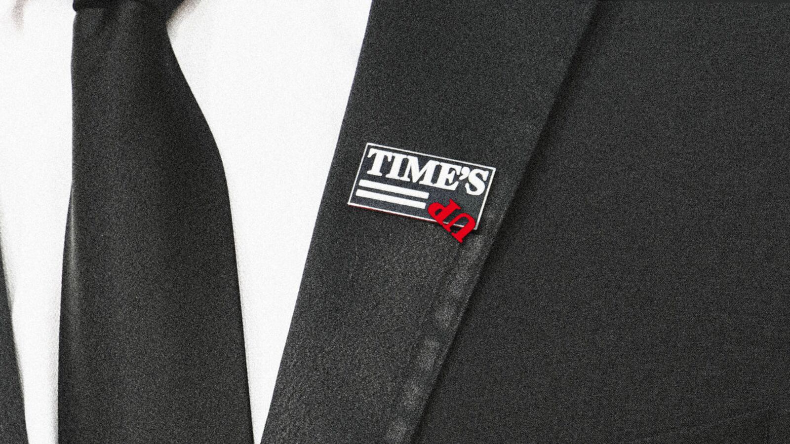 A photo illustration showing the Time’s Up movement pin, with the Up flipped upside down.