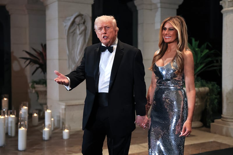President Donald Trump and first lady Melania Trump arrive for a New Year’s Eve event at his Mar-a-Lago home on December 31, 2025 in Palm Beach, Florida. The president called in to Fox & Friends on January 3  to brag about watching the strikes on Venezuela from his club.