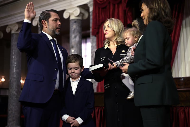 Vice President Kamala Harris participates in a ceremonial swearing-in with Sen. Ruben Gallego (D-AZ) (L) as his wife Sydney (3rd L), son Michael (2nd L) and daughter Isla look on at the U.S. Capitol on January 3, 2025 in Washington, DC.