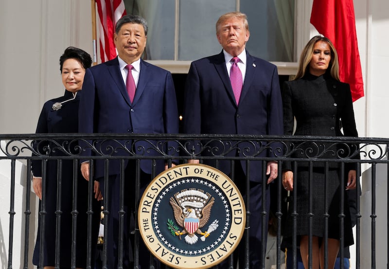 President Donald Trump, first lady Melania Trump, Chinese President Xi Jinping and his wife, Peng Liyuan watch a military demonstration from a balcony of the White House in Washington, D.C., September 24, 2026.