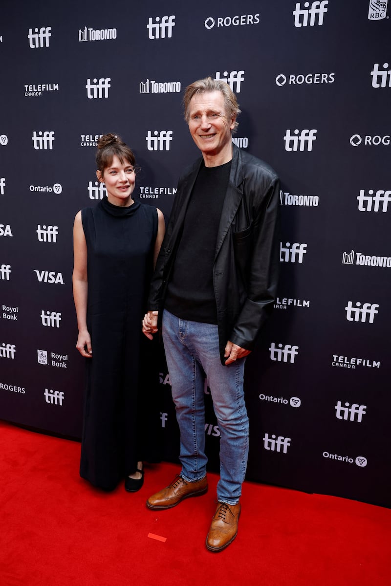 Liam Neeson and Stella Stocker attend the red carpet for "Evil Genius" at the Toronto International Film Festival (TIFF) in Toronto, Ontario, Canada, September 12, 2026. REUTERS/Carlos Osorio