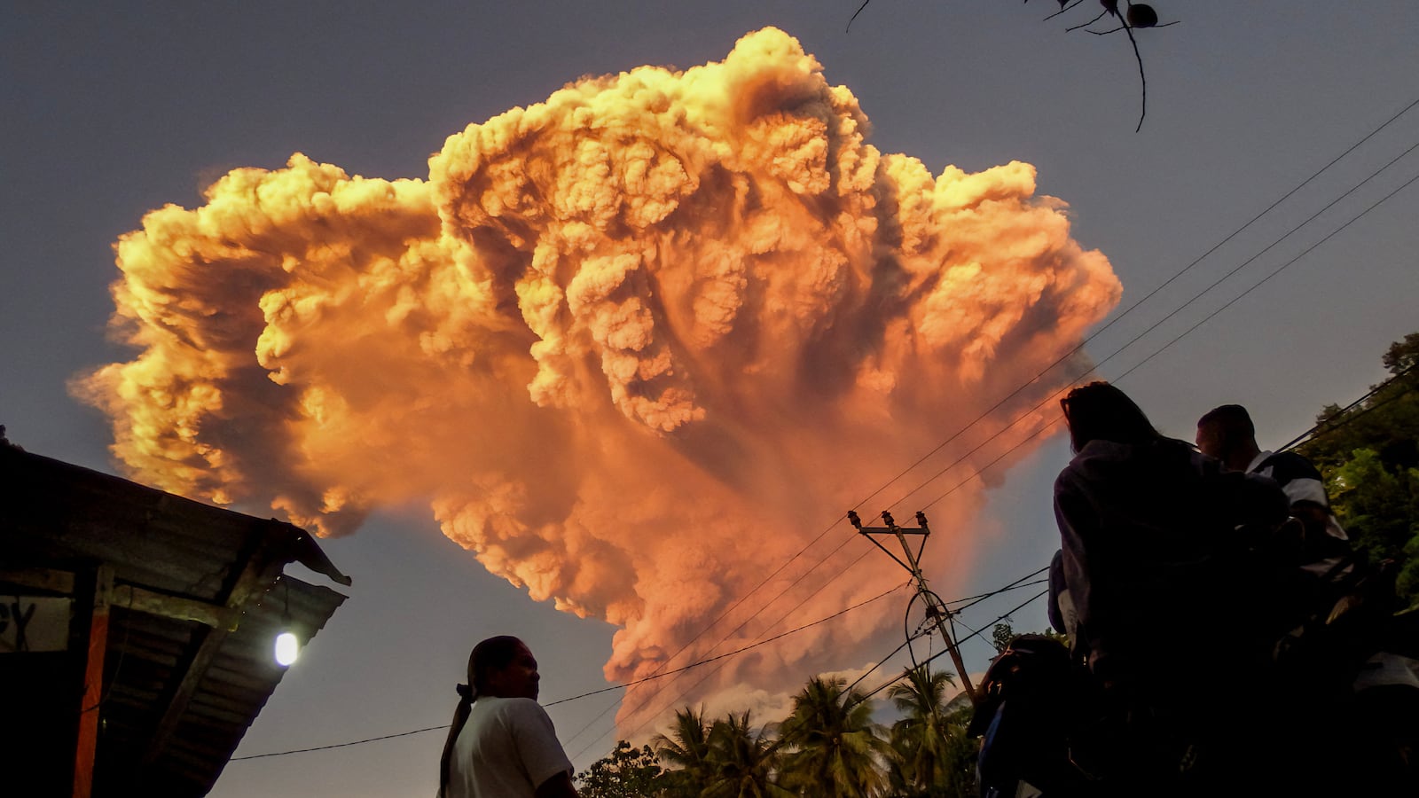 Villagers watch the eruption of Mount Lewotobi Laki-Laki as seen from Talibura village in Sikka, East Nusa Tenggara, on June 17, 2025. A volcano in eastern Indonesia spewed a colossal ash tower into the sky on June 17, authorities said, after they raised its alert level to the highest of a four-tiered system. (Photo by AFP) (Photo by STR/AFP via Getty Images)